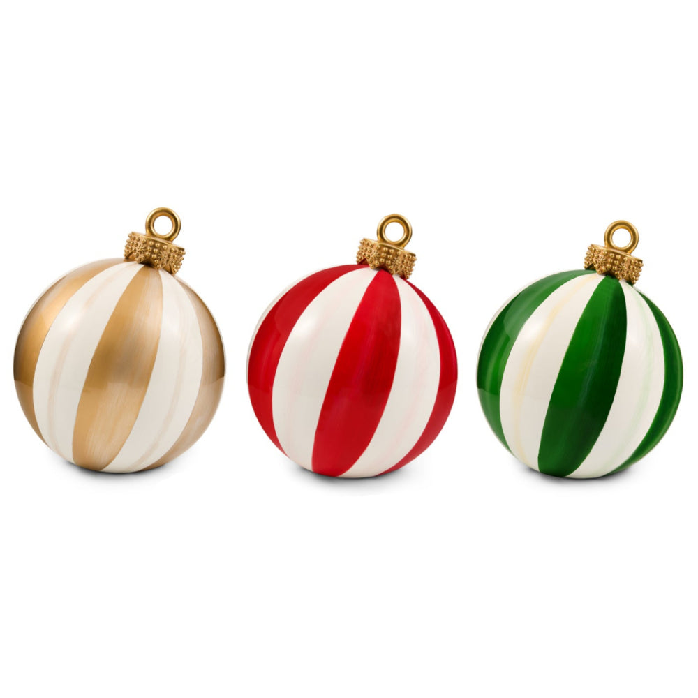 Three round Christmas ornaments with vertical stripes, shown side by side on a white background. The left ornament is cream and metallic gold, the middle is red and white, and the right is green and white.