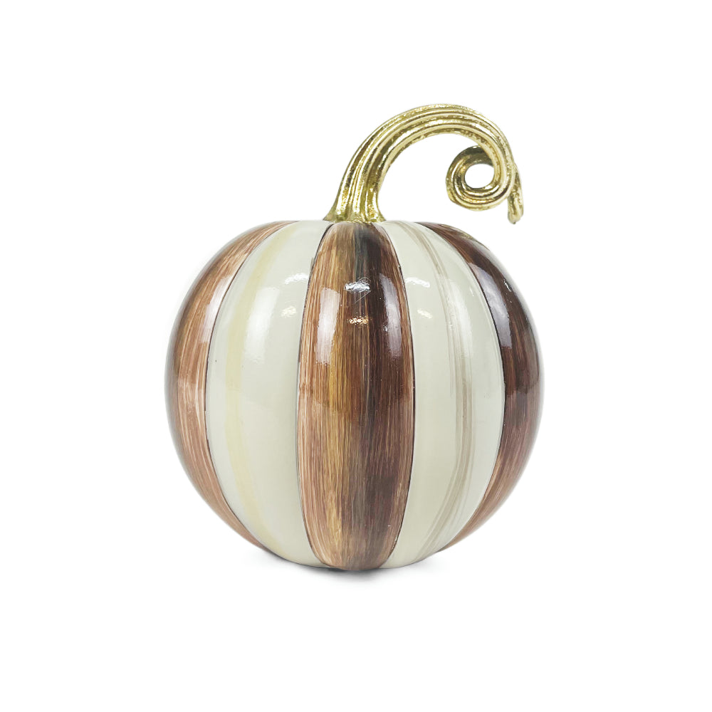 A decorative faux pumpkin ornament with vertical stripes in cream, light brown, and dark brown, featuring a glossy finish and a curled gold stem, shown on a plain white background.