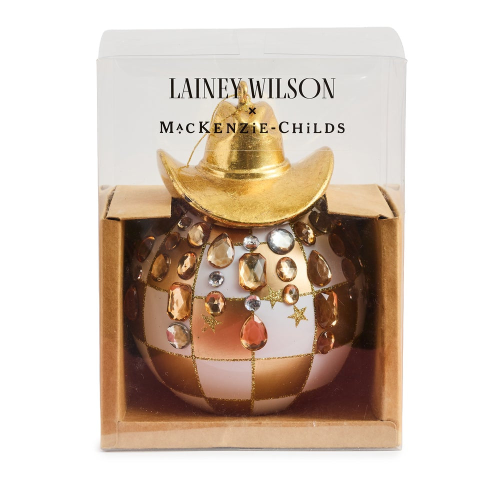 Gold check ornament with a gold cowboy hat on top with clear gems  in packaging on a white backround. 