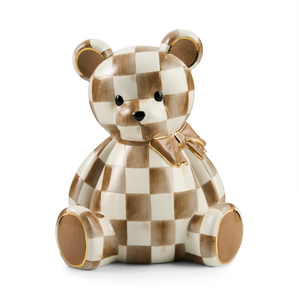 A ceramic teddy bear figurine featuring a brown and cream checkerboard pattern with gold accents on the ears, bow, and soles of the feet, set against a plain white background.