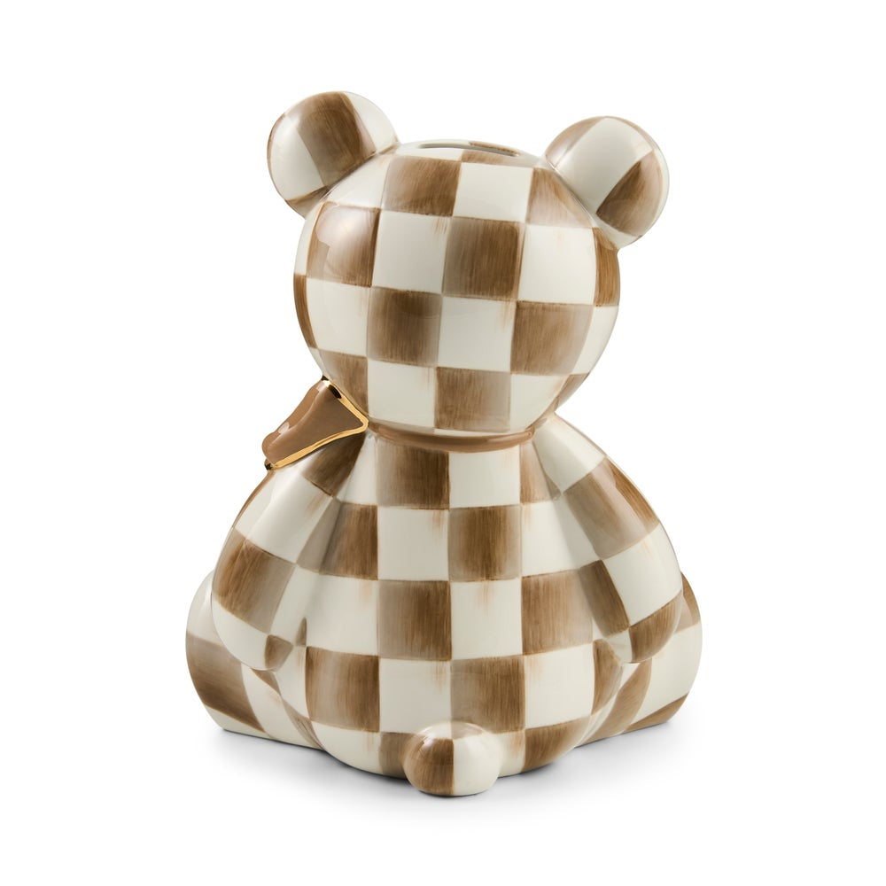 A ceramic bear-shaped pig bank featuring a brown and cream checkerboard pattern with a small gold accent on the neck, set against a plain white background.