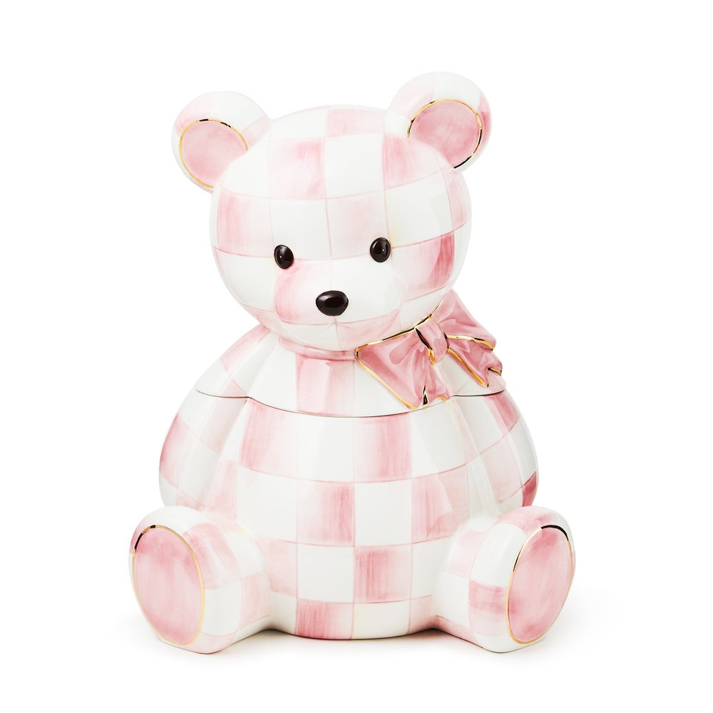 A ceramic teddy bear jar with a pink and white checkered pattern, featuring gold trim on the ears, paws, and bow, set against a plain white background.