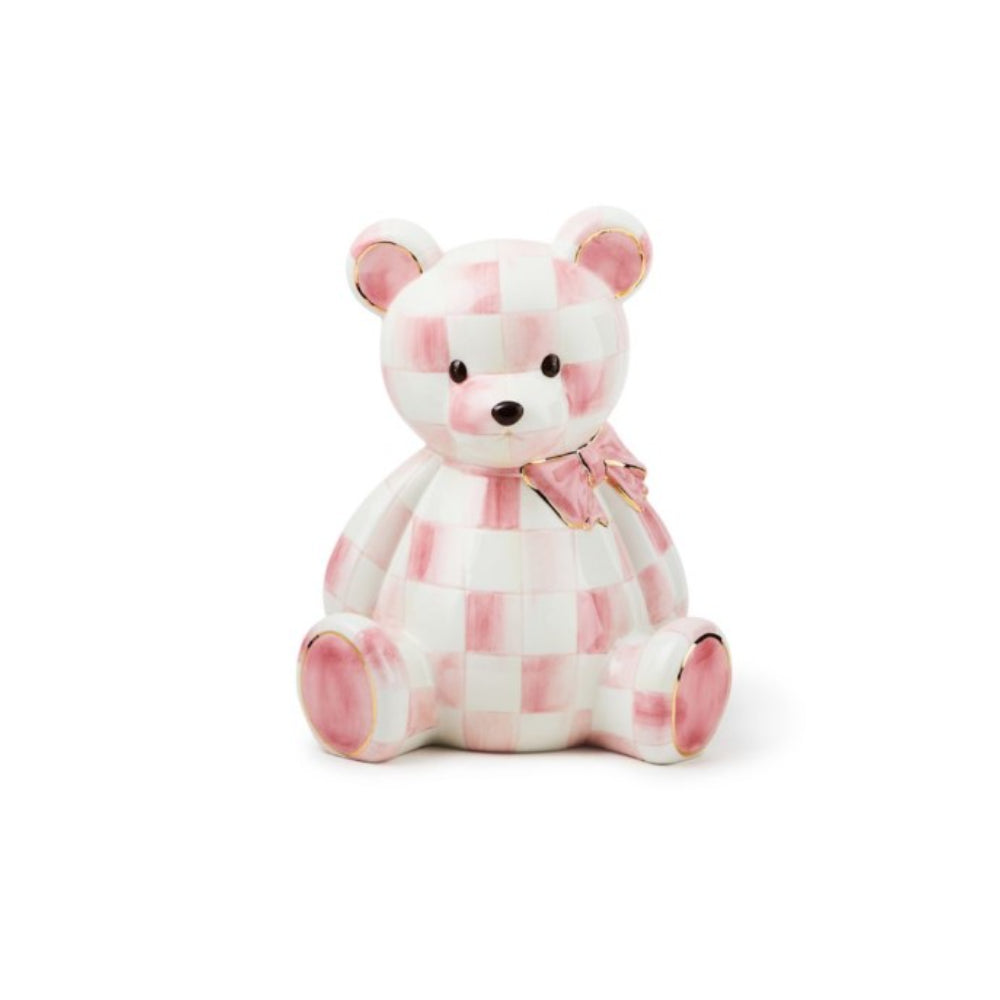 A ceramic bear bank with a pink checkered pattern and gold trim.