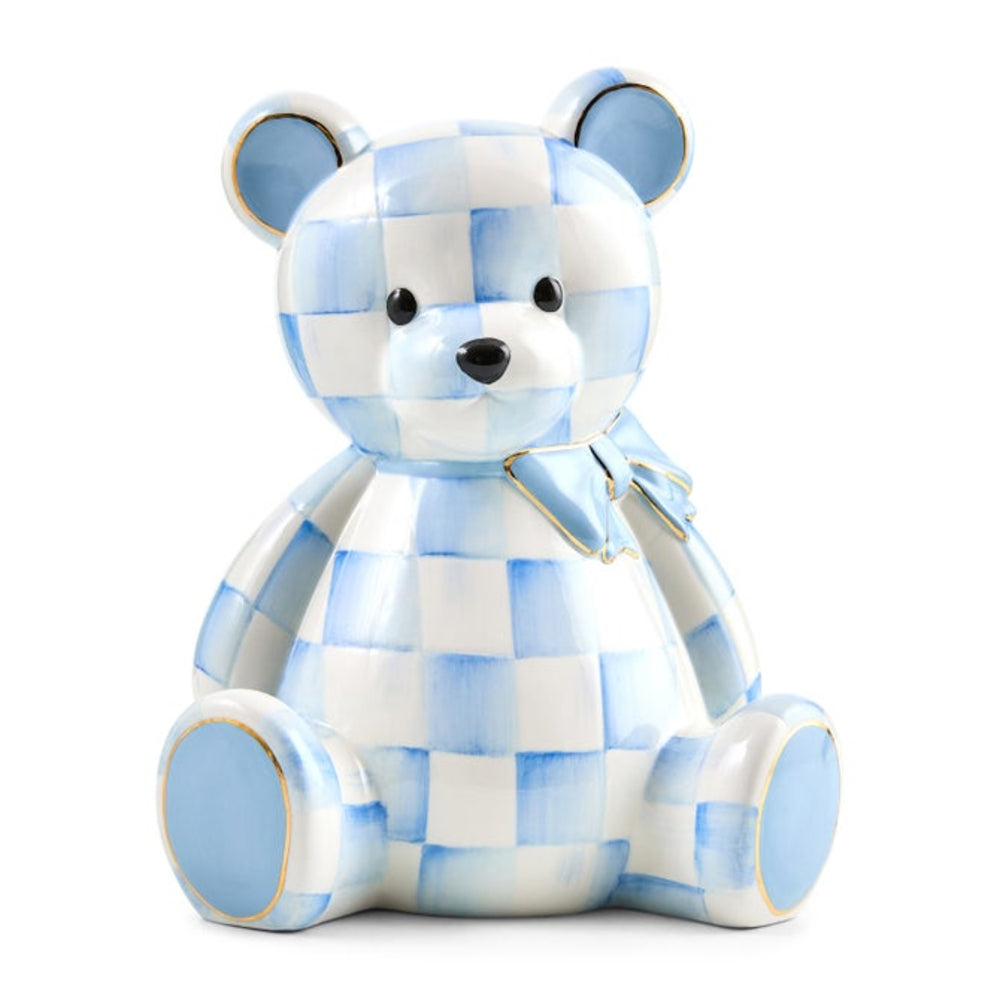 A ceramic teddy bear figurine with a light blue and white checkered pattern, featuring a matching bow on its neck, set against a plain white background.
