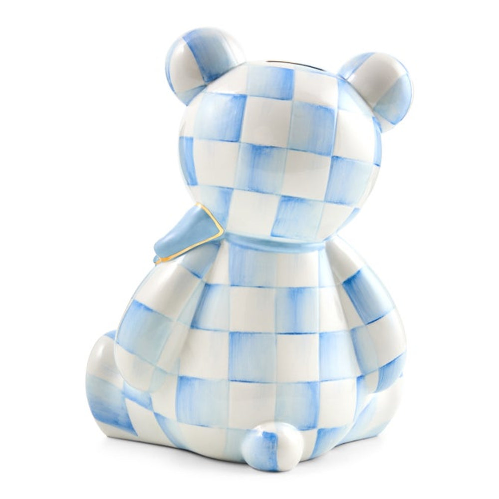 A ceramic pig bank shaped like a teddy bear, featuring a light blue and white checkered pattern with a small gold accent on the collar, set against a plain white background.