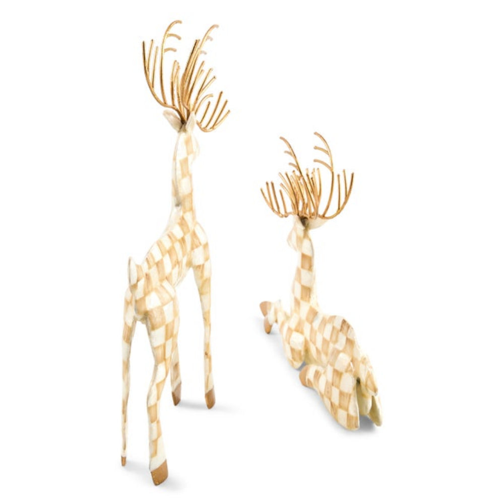 Two decorative reindeer figurines with a cream and tan checkerboard pattern and gold antlers, shown standing and lying down on a white background.