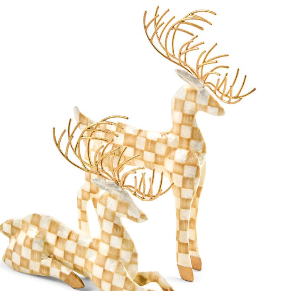 Two decorative deer figurines with a beige and white checkered pattern and metallic gold antlers, shown on a plain white background.