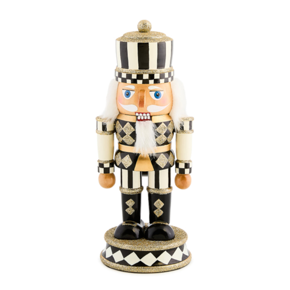 Decorative nutcracker figurine with black and white checkered pattern on a white background