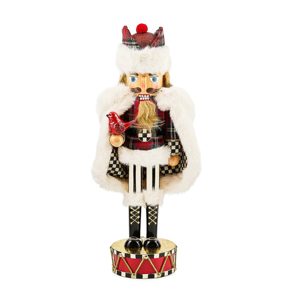 Decorative nutcracker figure in Scottish-themed costume on a white background.