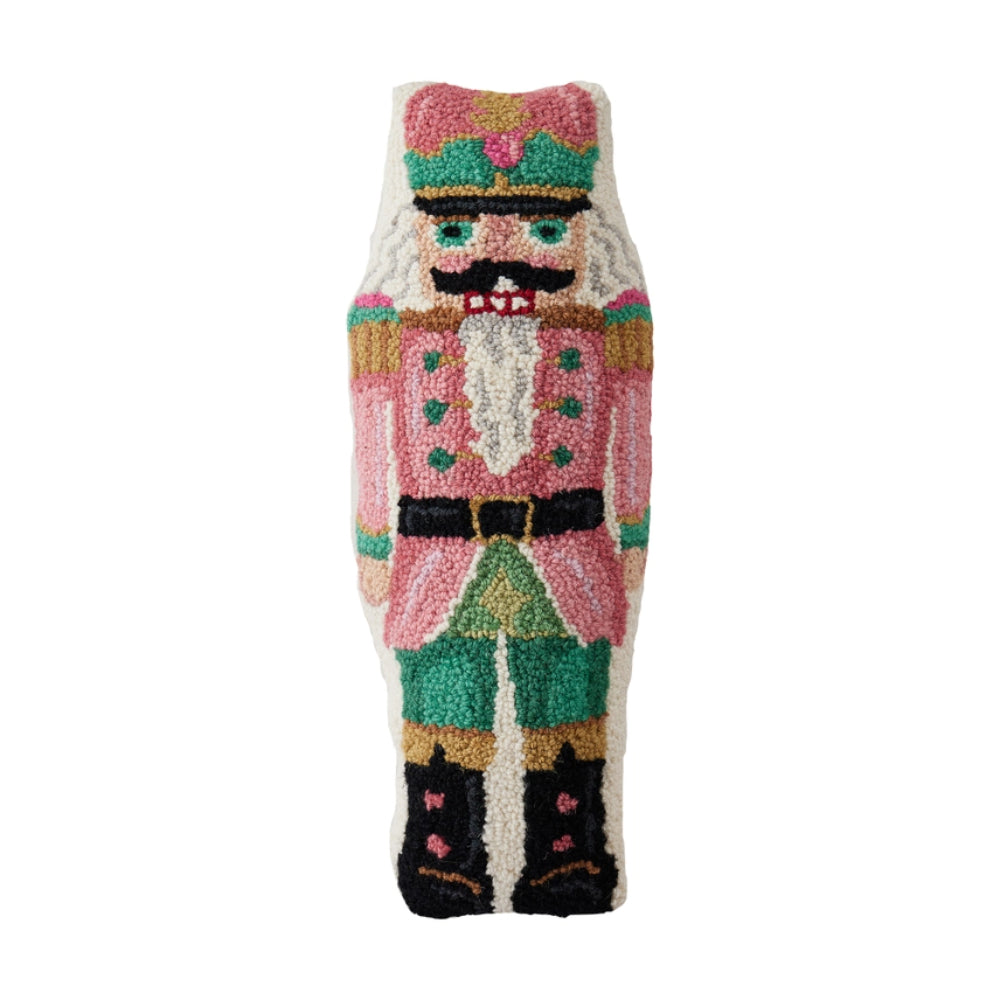 Colorful nutcracker-themed pillow on a white background