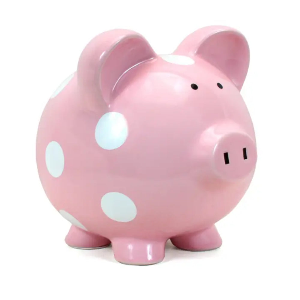 Pink piggy bank with white polka dots on a white background