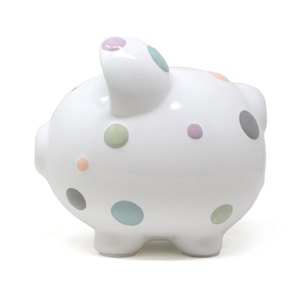 Left side photo of a white piggy bank with colorful polka dots on a white background