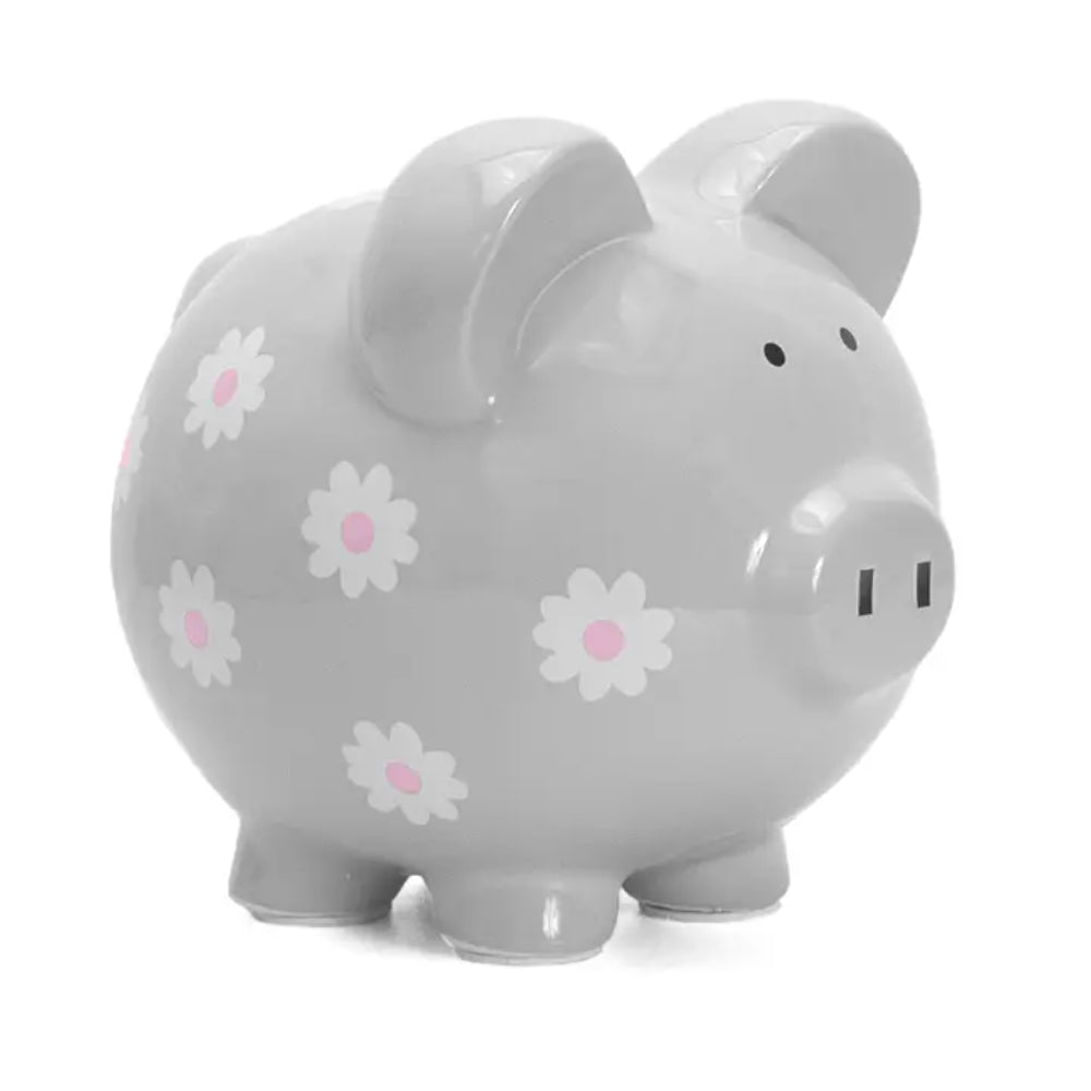 A gray ceramic piggy bank with white and pink daisy patterns on its side.