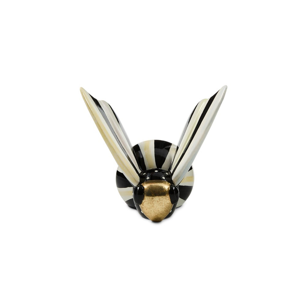 A decorative wall hook shaped like a wasp, featuring black and cream stripes with a metallic gold head, shown against a plain white background.