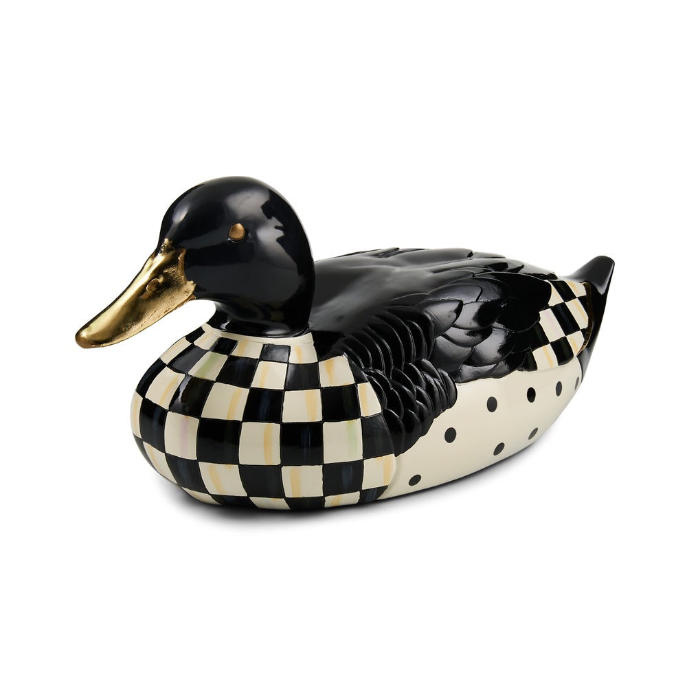 A decorative duck figurine with a glossy black head and back, a black-and-cream checkerboard patterned body, cream polka dots on the side, and a metallic gold beak, shown on a white background.