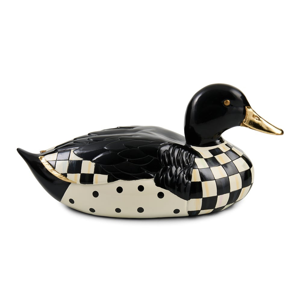 A decorative duck figurine with a glossy black head and back, cream-and-black checkerboard patterned body, black polka dots on the underside, and a gold beak and eye detail, shown on a plain white background.
