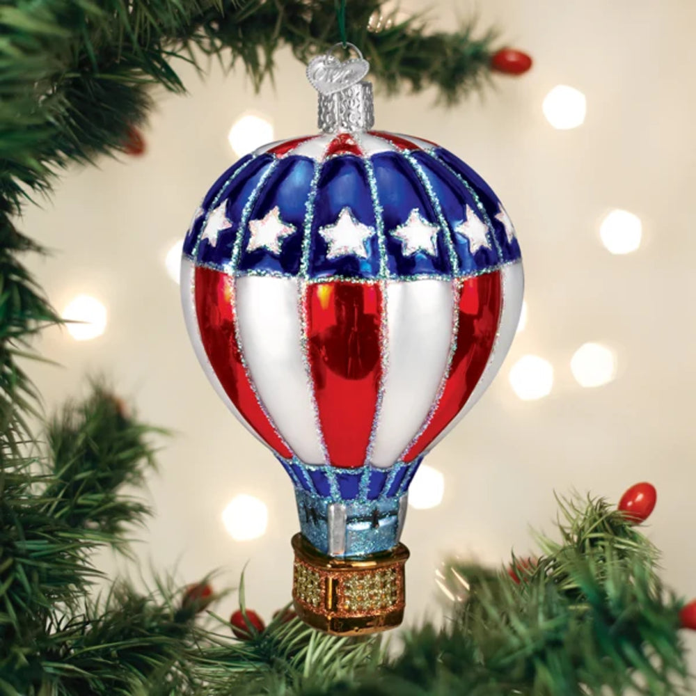 Decorative hot air balloon ornament with American flag design on a Christmas tree.