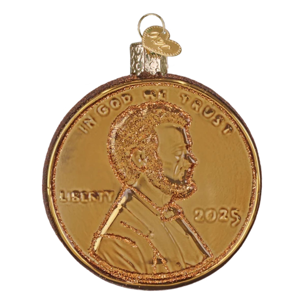 A gold-colored penny Christmas ornament featuring a profile portrait of Abraham Lincoln with glittery gold accents and the year 2025, complete with a hanging loop at the top.