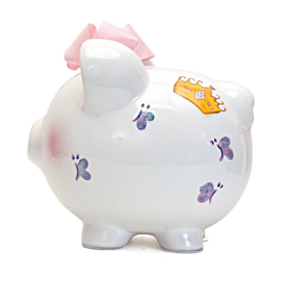 A Princess Castle Piggy Bank with   butterflies, a crown, and a pink bow on a white background.