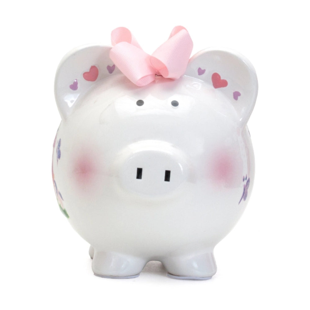 A Princess Castle Piggy Bank with  hearts, and a pink bow on a white background.