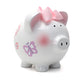 A white ceramic piggy bank with pink and purple butterfly decorations, pink ears, and a pink bow on top.