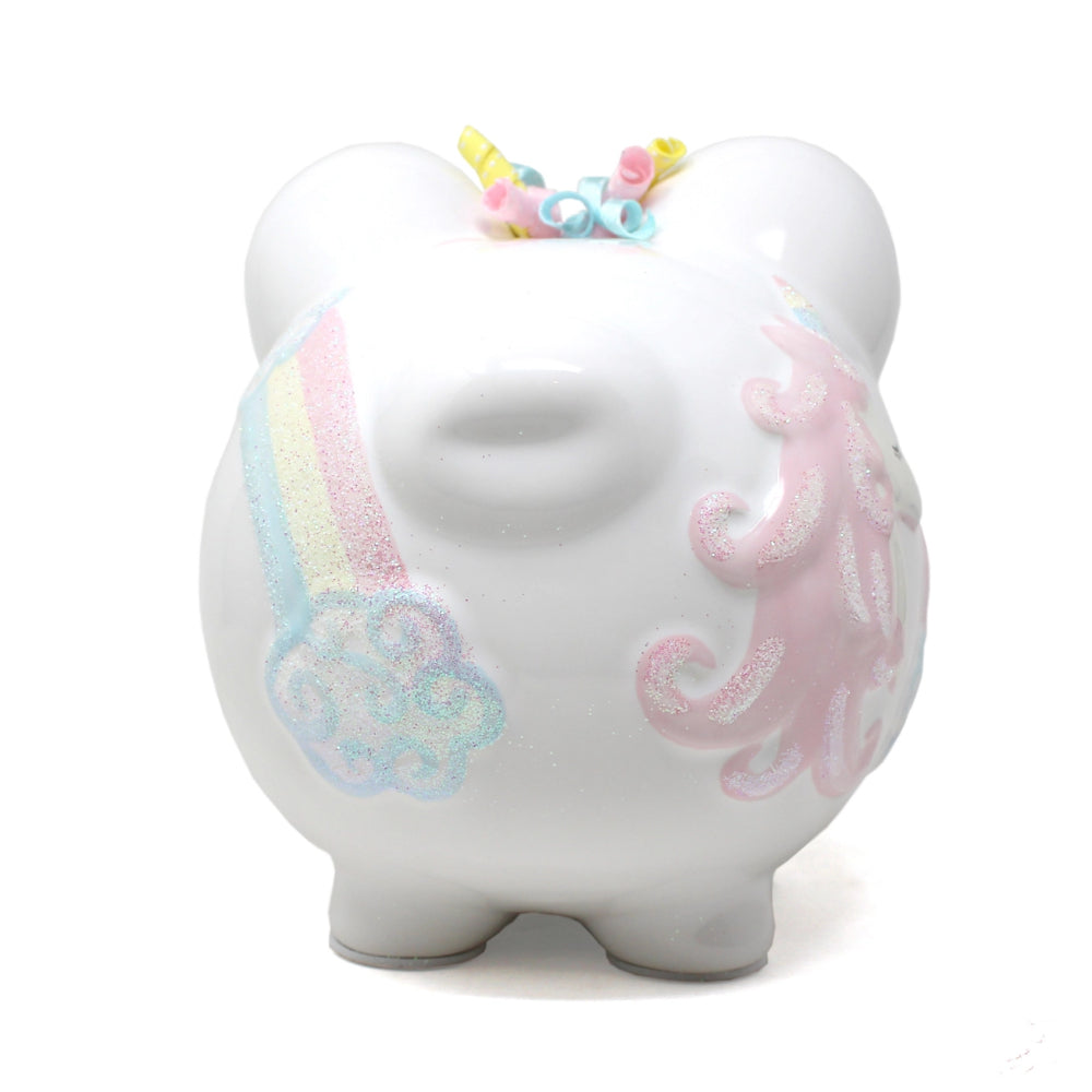 White piggy bank with unicorn design and colorful accents on a white background