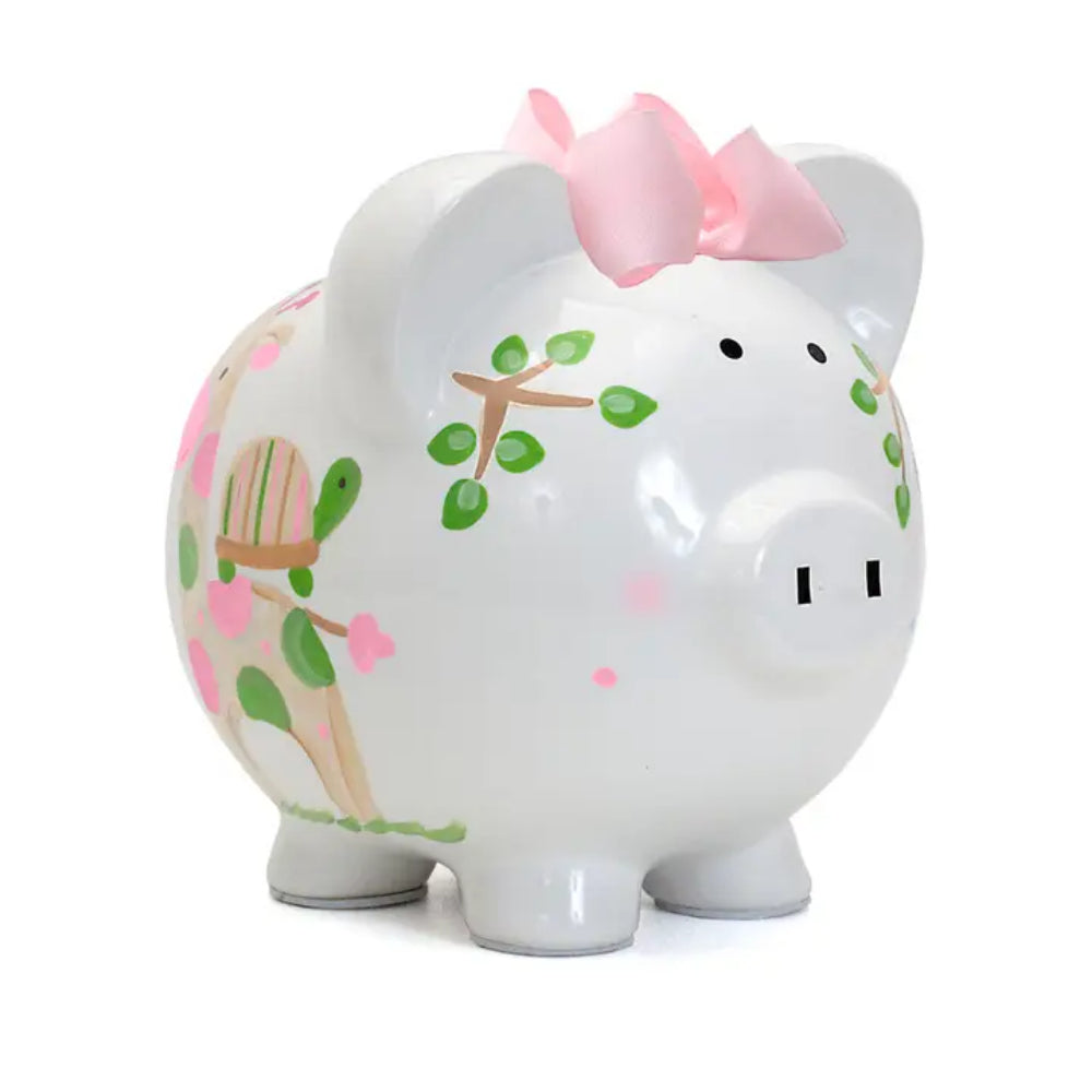 White piggy bank with pink bow and colorful designs on a white background