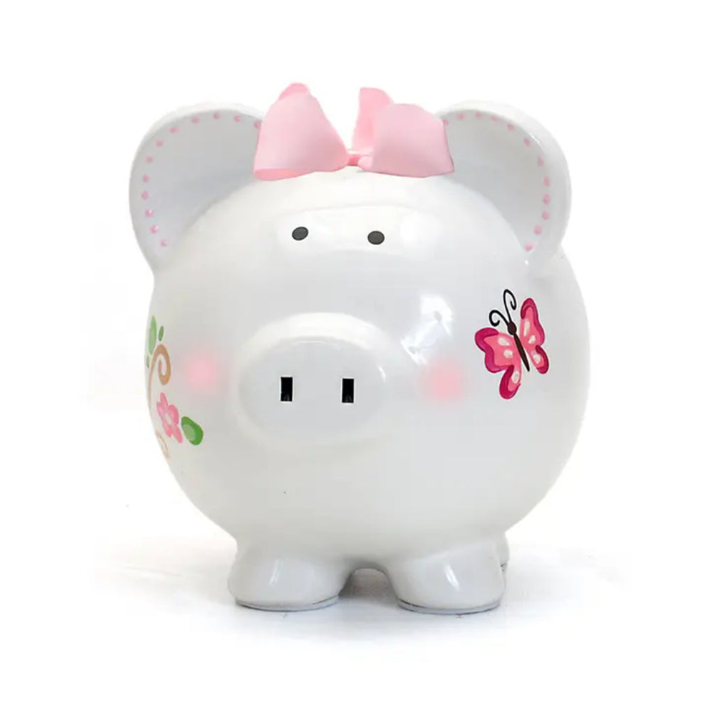 White piggy bank with pink bow and butterfly design on a white background