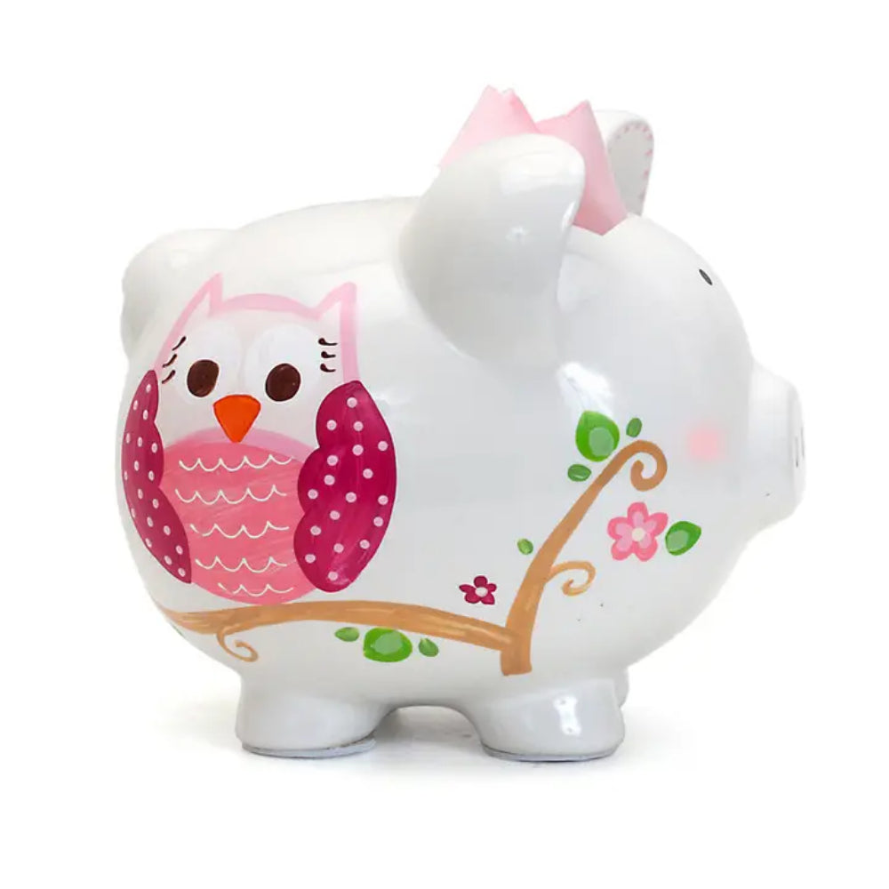 White piggy bank with pink owl design on a white background