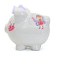 White piggy bank with a pink fairy design and pink crown with a purple bow on a white background