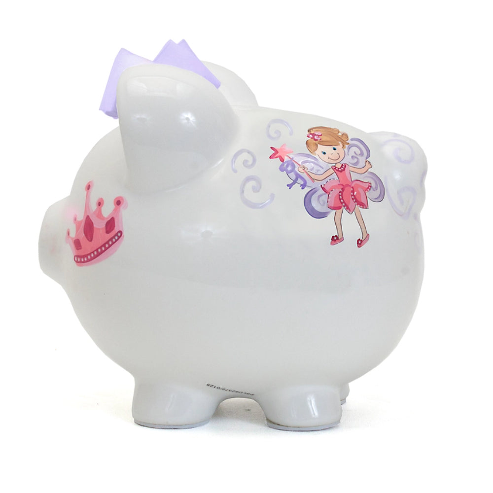 White piggy bank with a pink fairy design and pink crown with a purple bow on a white background