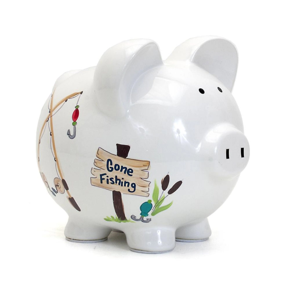 A white ceramic piggy bank with a 'Gone Fishing' theme, featuring fishing rods, lures, and a sign.