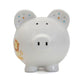 White piggy bank with lion and polka dot designs on white background. 