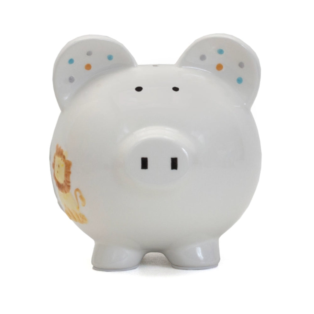 White piggy bank with lion and polka dot designs on white background. 