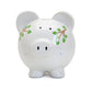  Photo of the front of a white piggy bank with plant designs on a white background