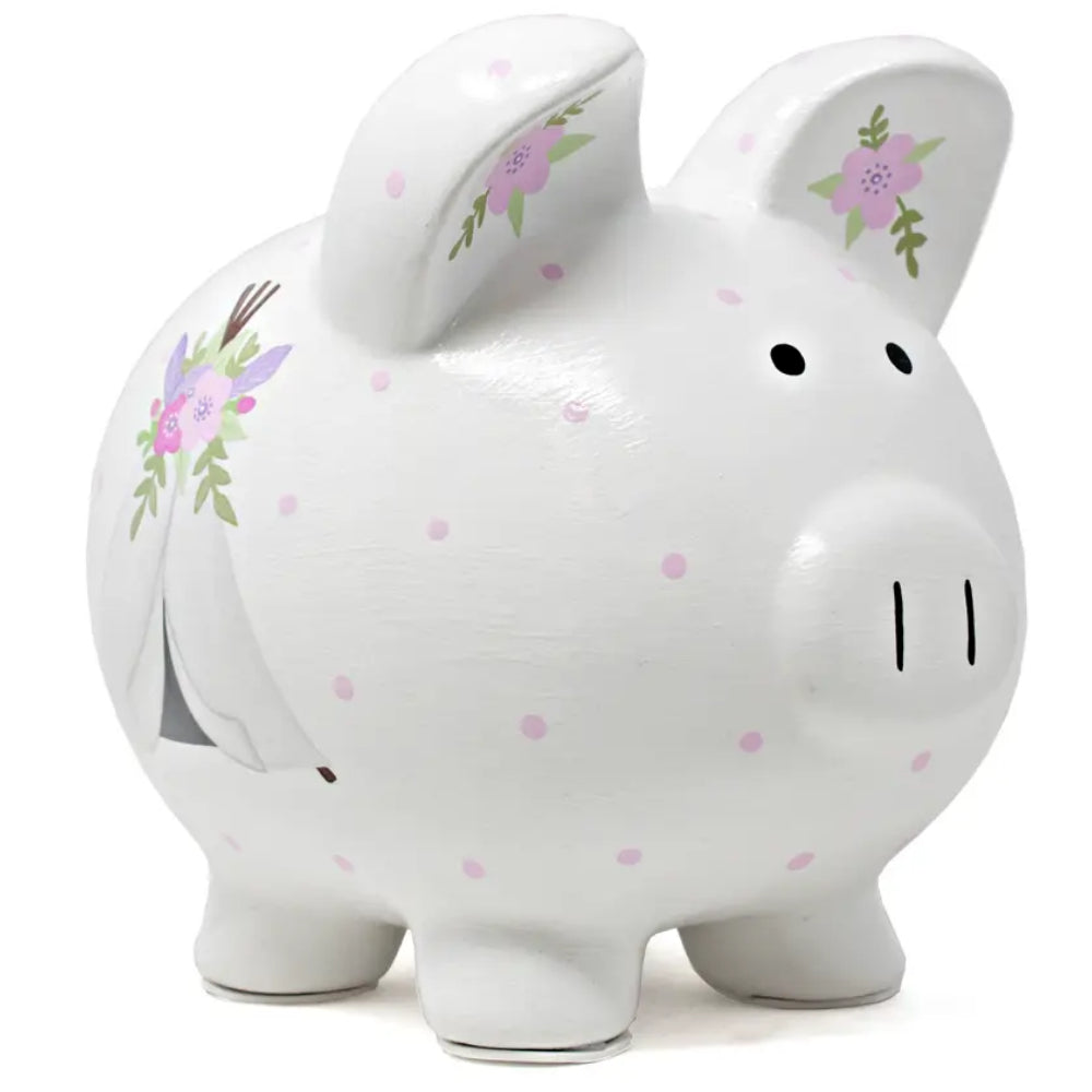 A piggy bank with purple polka dots and floral designs on white background. 