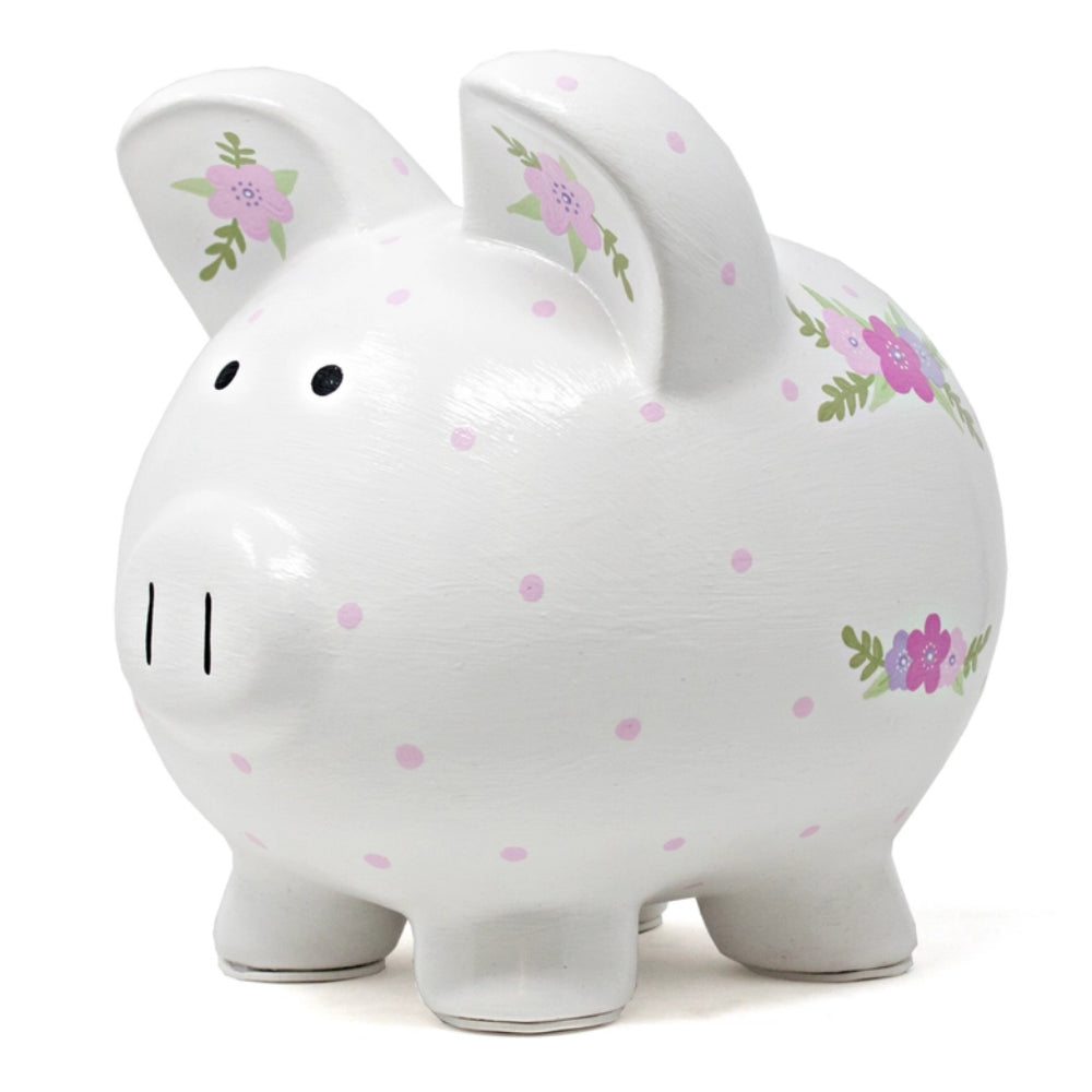 A piggy bank with purple polka dots and floral designs on white background. 