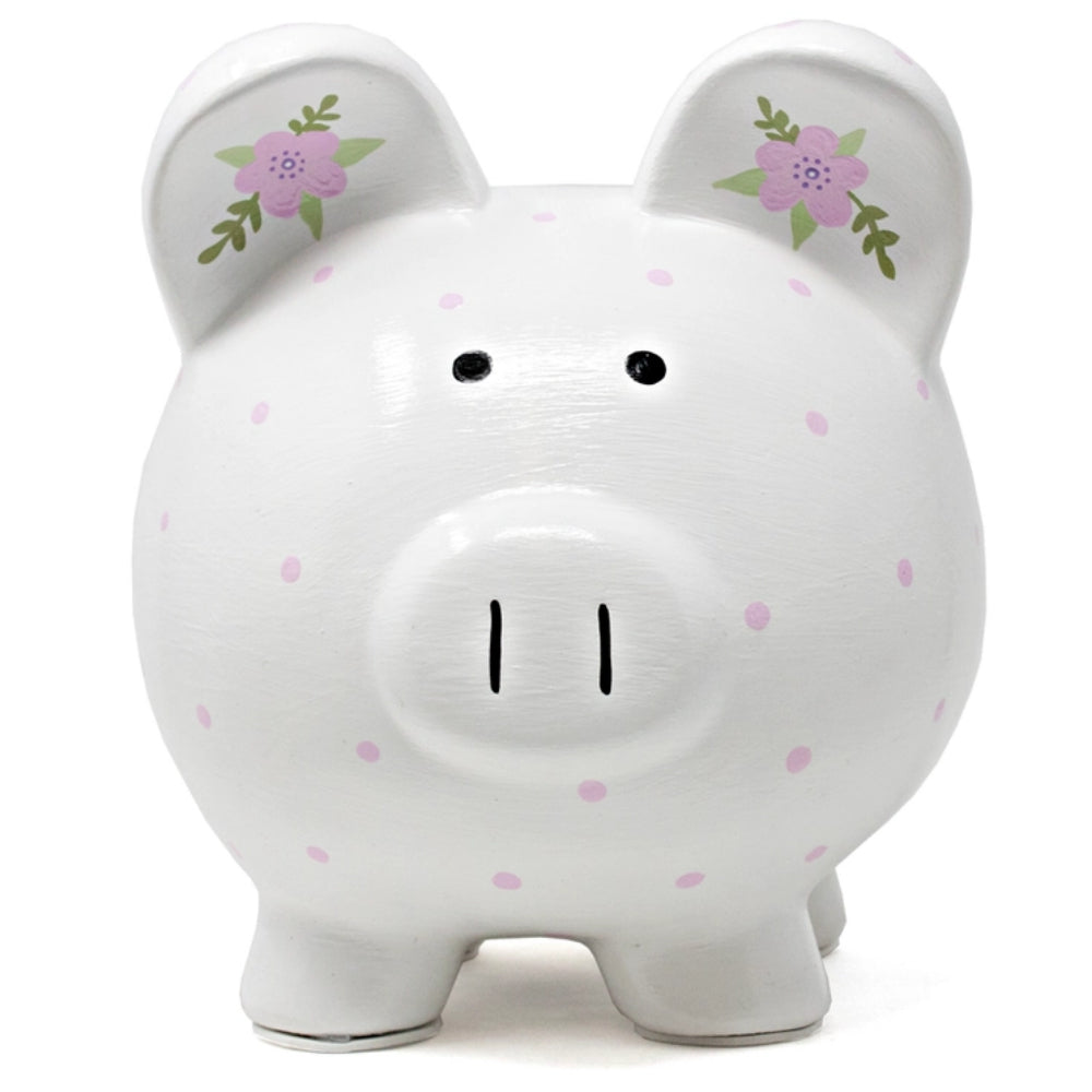 A piggy bank with purple polka dots and floral designs on white background. 