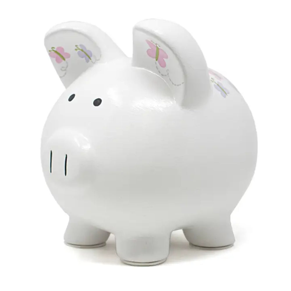 A glossy white ceramic piggy bank shaped like a pig, featuring small pink and purple butterfly illustrations on its ears and back, set against a plain white background.