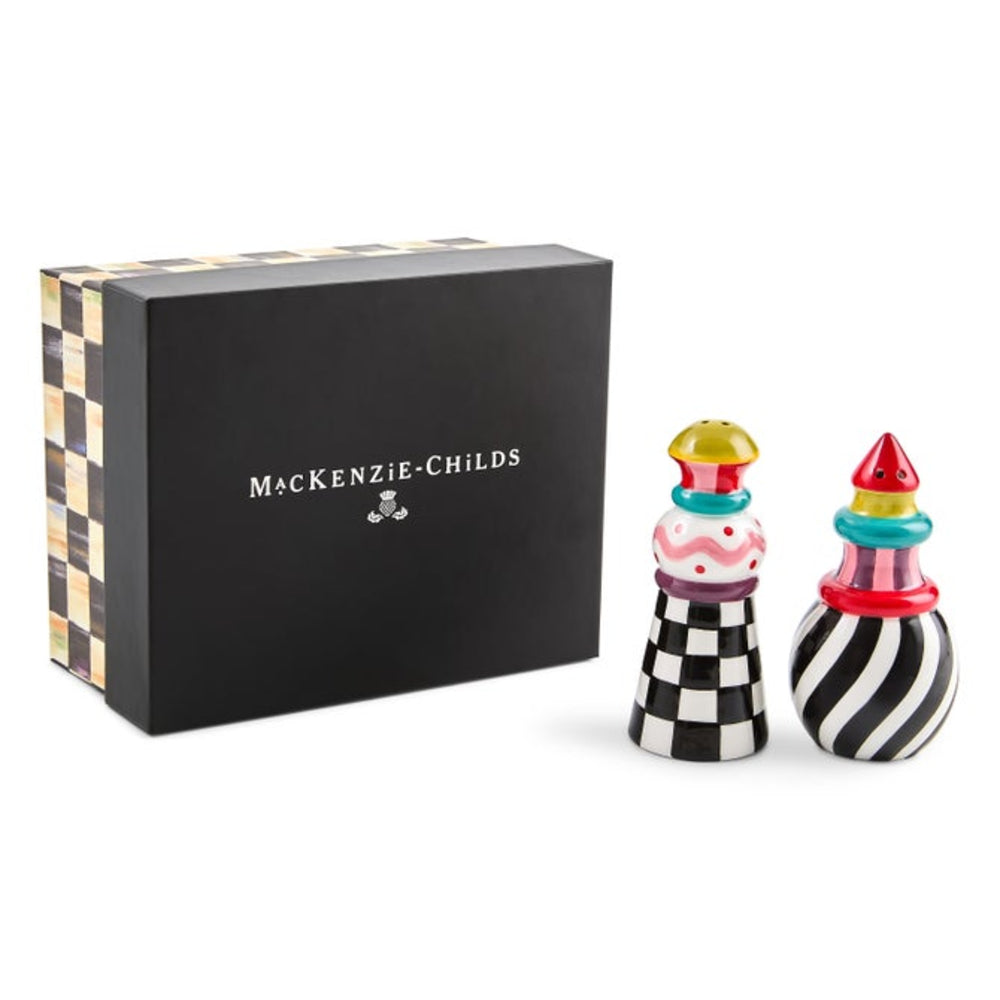 MacKenzie-Childs salt and pepper shakers with a black and white checkerboard and striped design, shown next to their black presentation box on a white background.