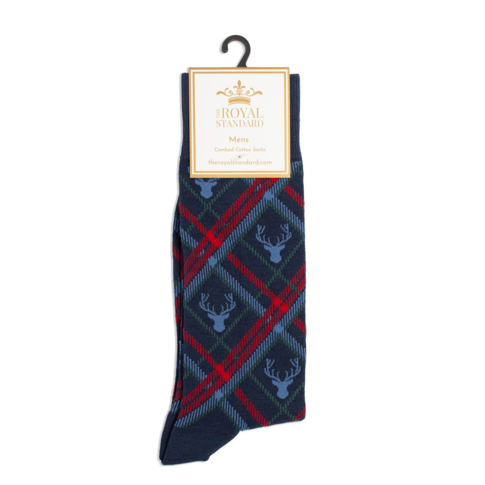 A pair of Royal Standard men's knit socks hanging from a black plastic hanger with a paper brand label. The socks feature a navy blue base with a red and blue tartan plaid pattern and light blue deer head motifs.