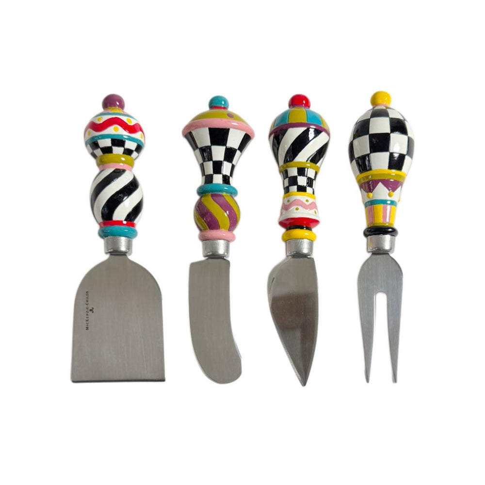 Four decorative cheese and spread utensils with colorful patterned handles and stainless steel blades, arranged side by side on a plain white background.