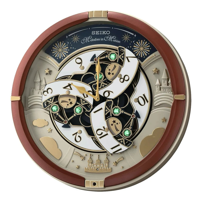 Seiko Modern in Motion wall clock featuring a circular design with a reddish-brown outer frame, gold-toned details, and a complex dial with white and black segments, gold hands, and green crystal accents.