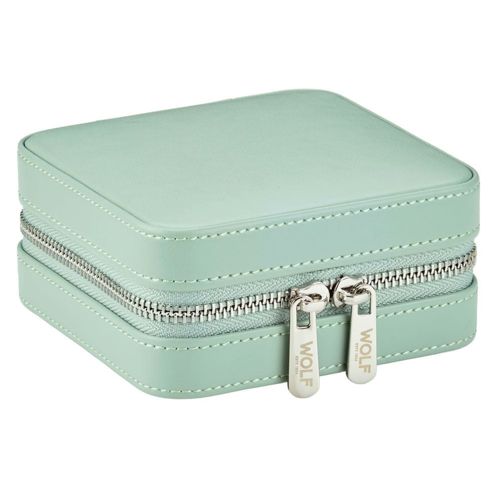 Mint green jewelry case with silver zipper on a white background