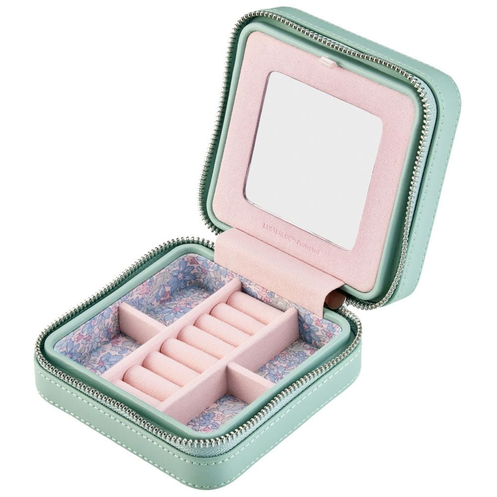 Mint green jewelry box with pink interior, open to reveal jewelry compartments.