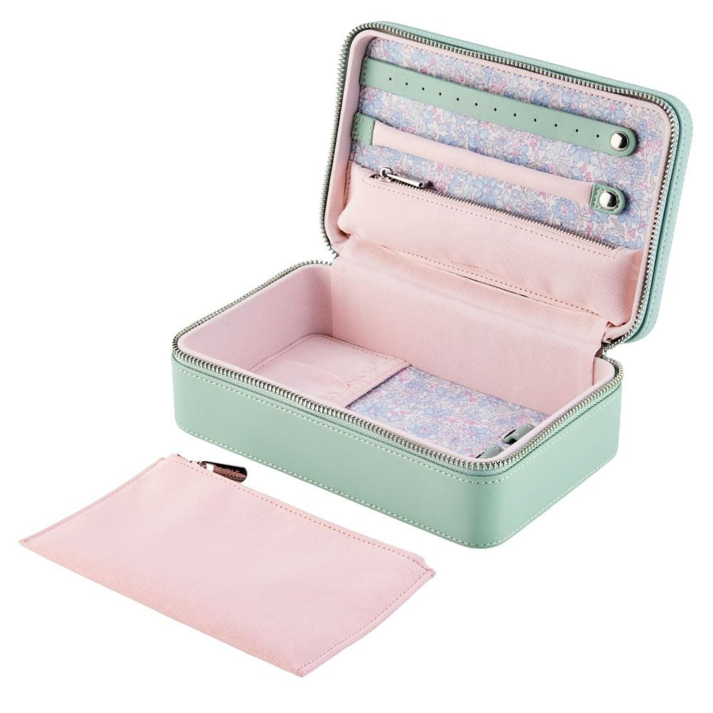 Open jewelry case with pink interior and matching pouch on a white background