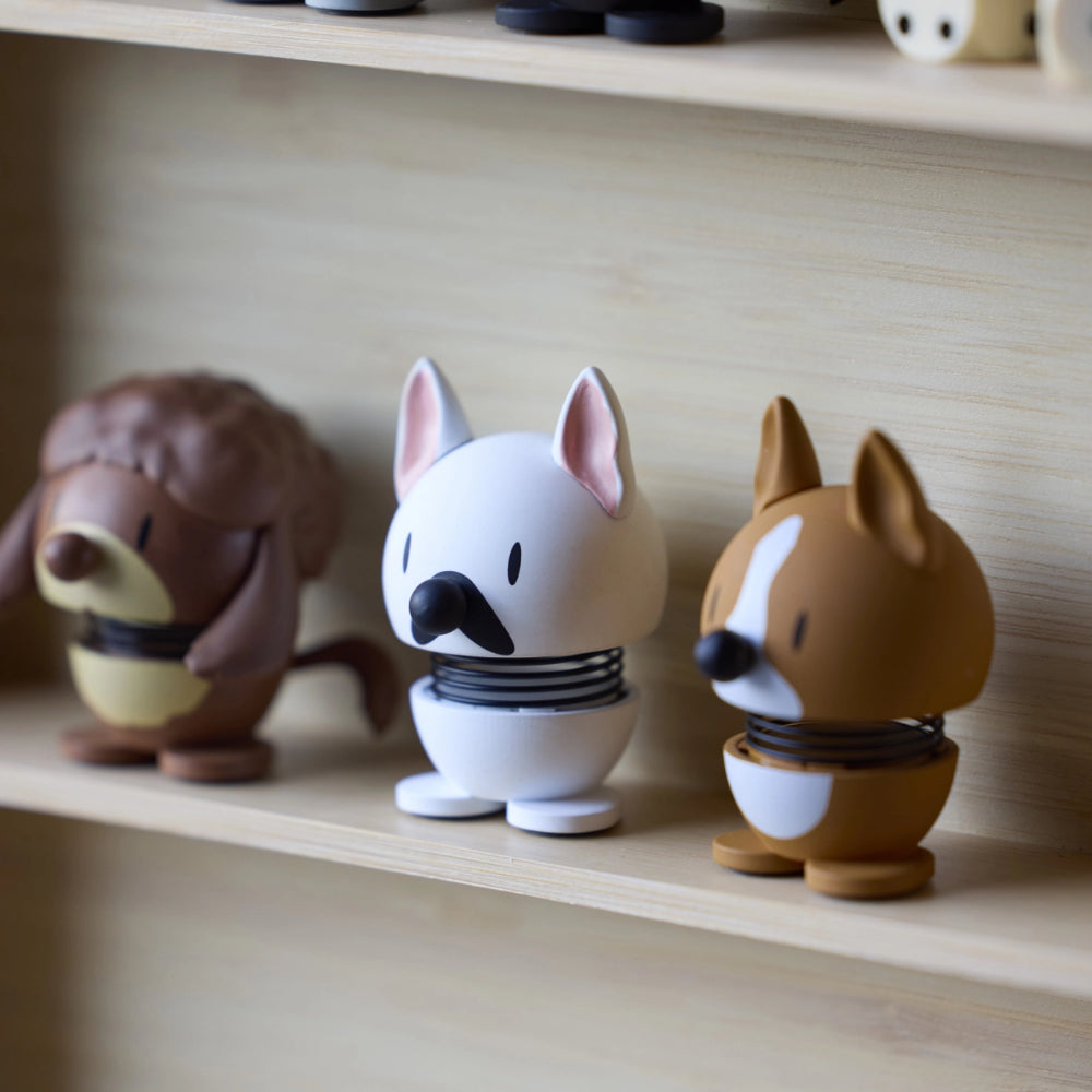 Three small animal figurines on a wooden shelf