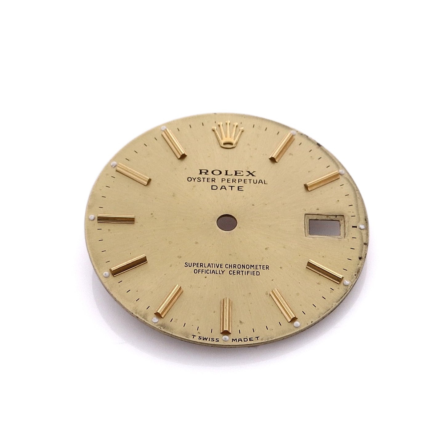 A champagne Rolex watch dial with stick indexes and a date display window.