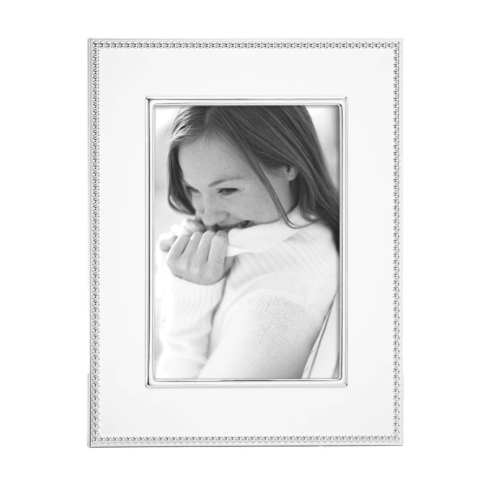 5x7 Lyndon Silverplate Frame with with a decative silver egde with black and white photo of a woman in a white sweather on a white backround. 