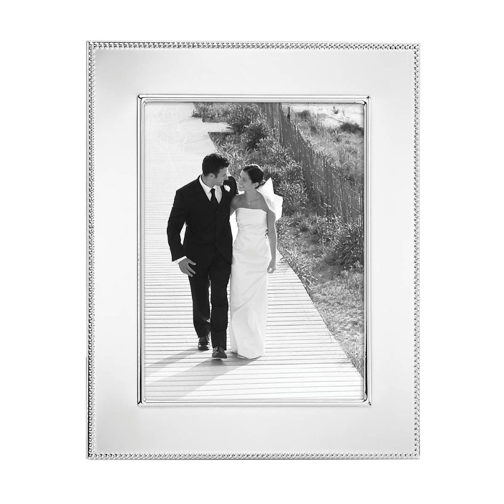 Lyndon 8x10 Silverplate Frame with with a decative silver egde with black and white photo of a couple on thier wedding day on white backround. 